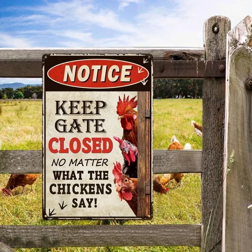 A rustic metal chicken coop sign mounted on a wooden farm gate and a backyard poultry wire fence showing dimensions of aluminum plaques