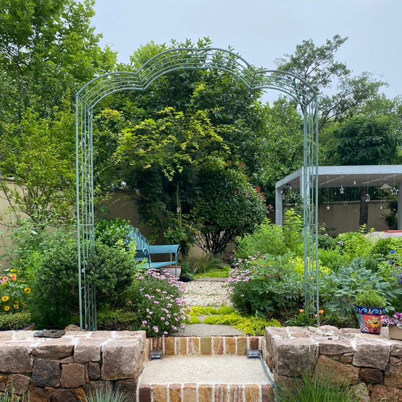 Metal garden trellis arch serves as garden arch and supportive trellis for climbing plants