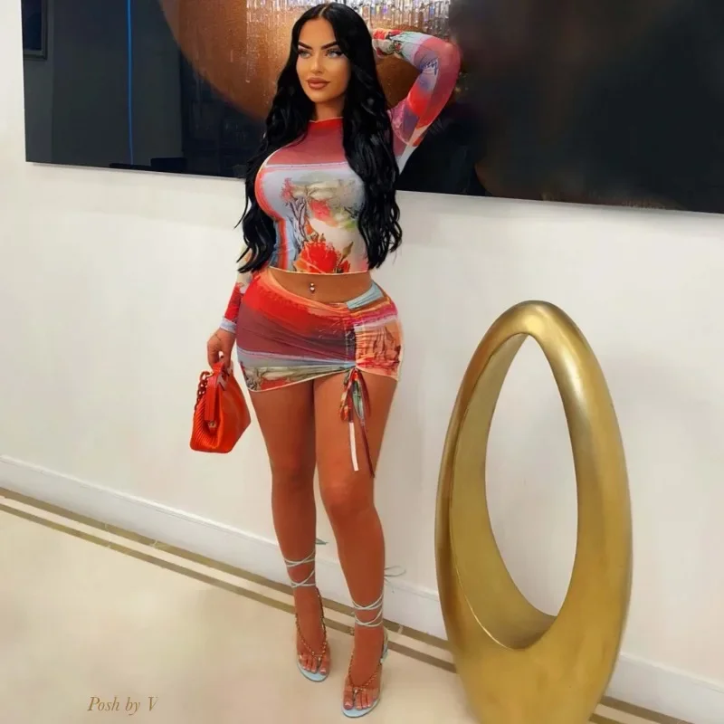 

Fashion Print Mesh 2 Piece Set Women Sexy O-Neck Long Sleeve Slim Crop Tops Drawstring Pleated Hipster Mini Skirts Clubwear Suit