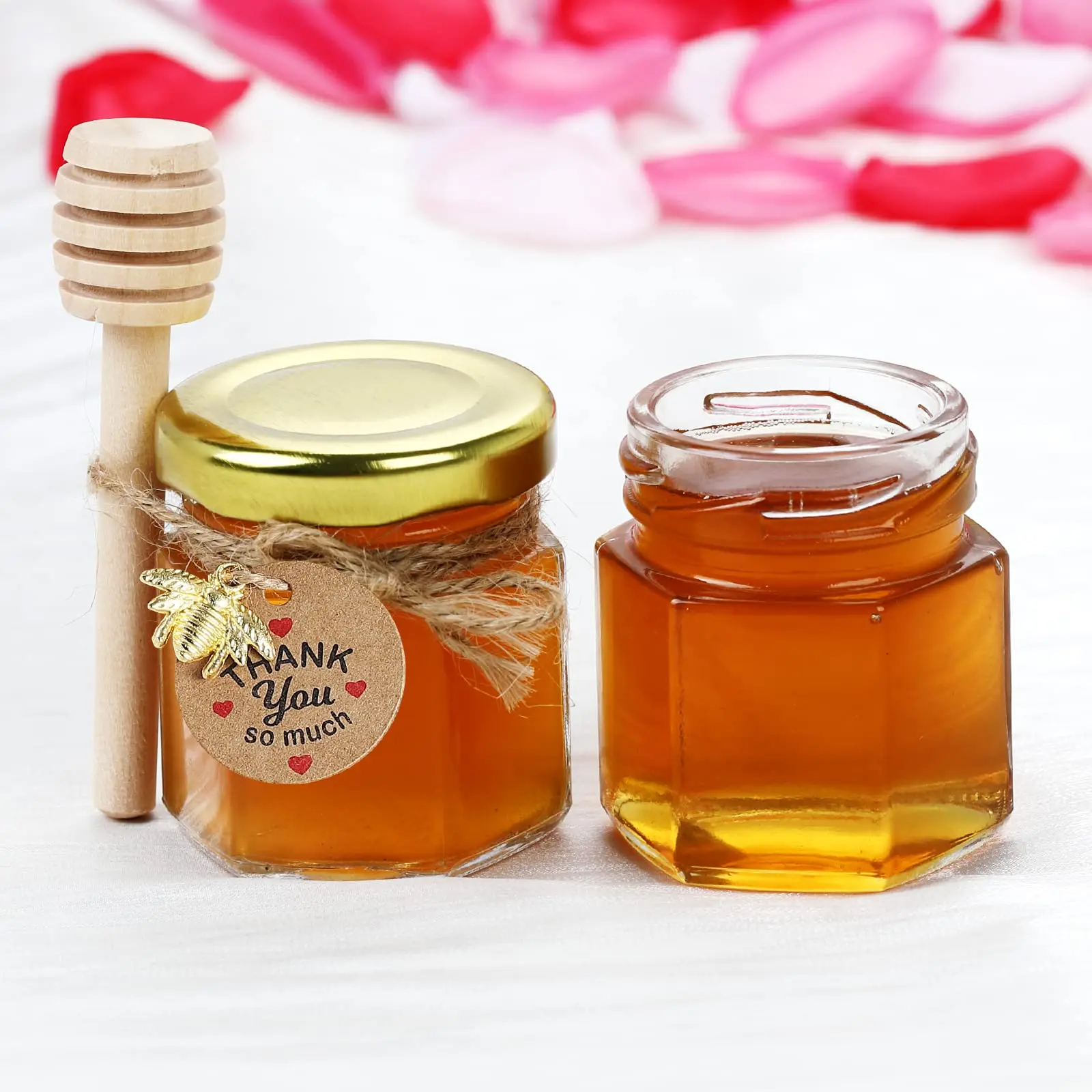 Hexagon mini honey jars with gold lids, wooden dippers, bee charms, and jute twine. Perfect for baby showers, 20-pack.