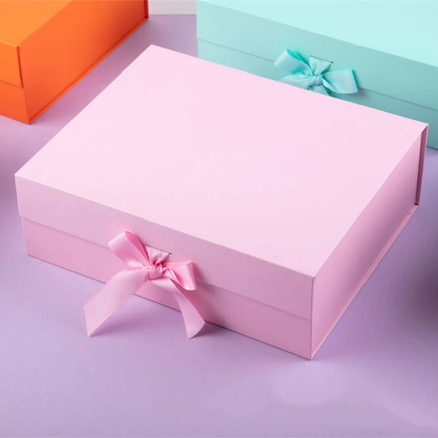 Premium Photo  Small gift box with bow pink and silver ribbon for gift  wrapping on pink background