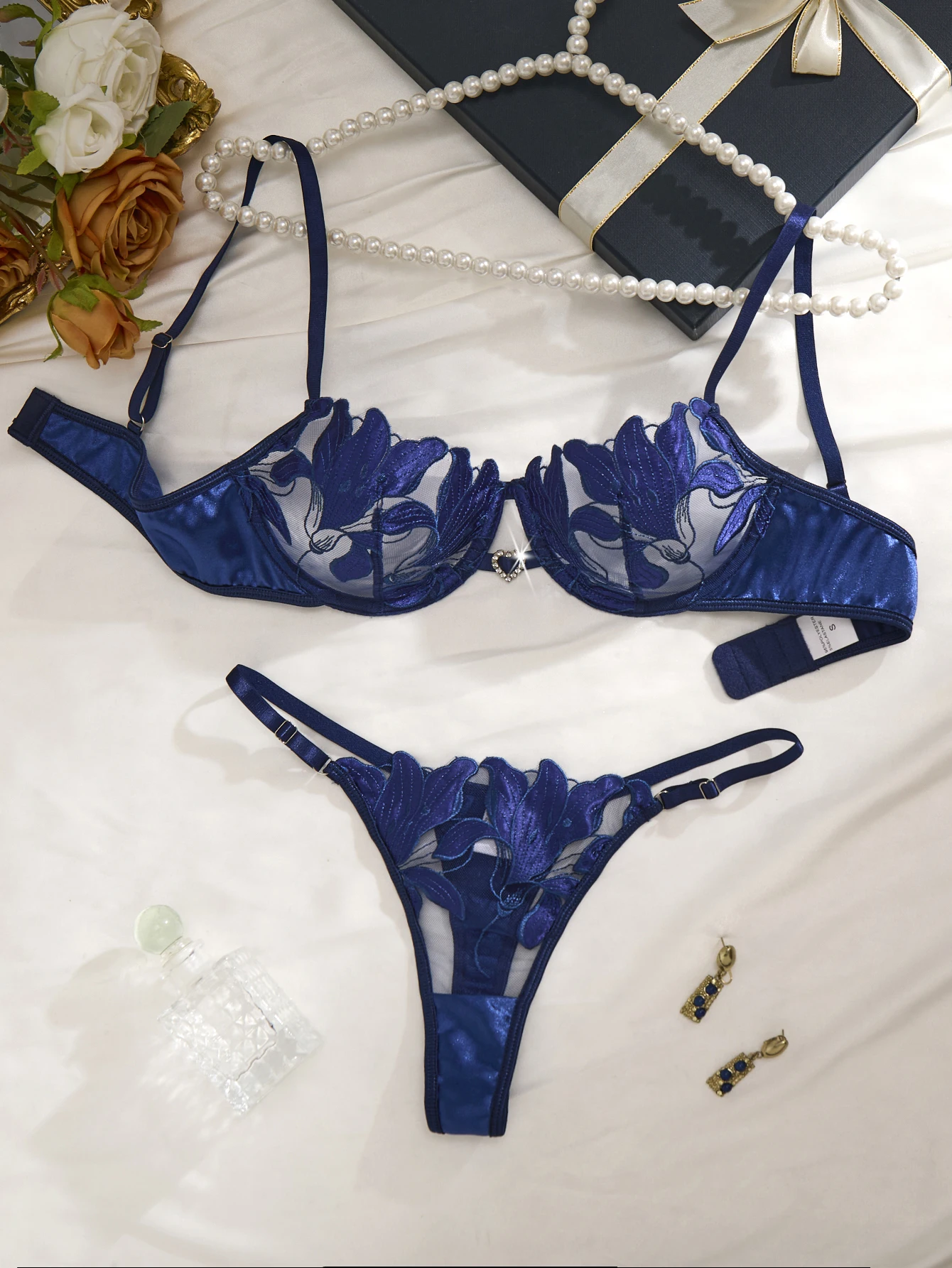 Blue lingerie set with floral mesh cups, push-up shape, and matching thong