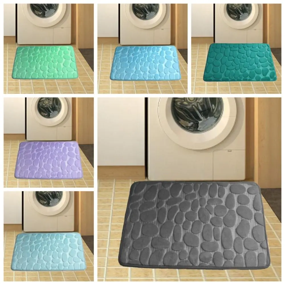 Cobblestone-patterned grey bath mat with non-slip backing for bathroom floor use.