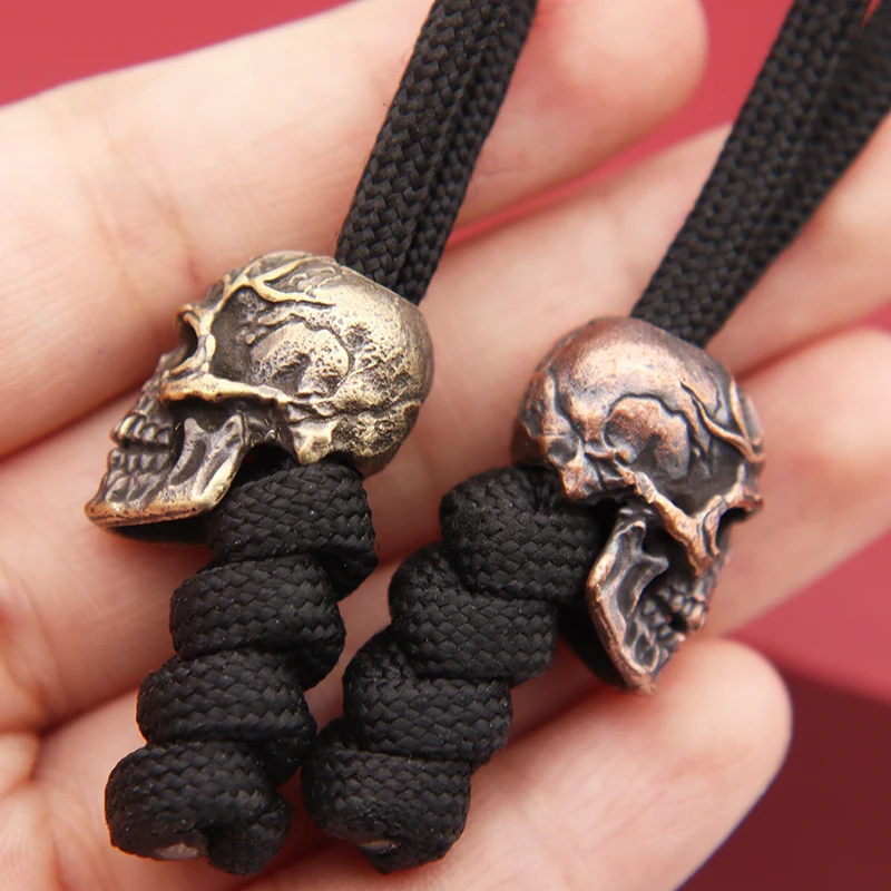 https://ae01.alicdn.com/kf/S121e9b407af24456a75451df79b853ba6/Three-Eyes-Skull-Head-Brass-Knife-Beads-EDC-Outdoor-DIY-Paracord-Accessories-Woven-Lanyard-Pendant-Jewelry.jpg