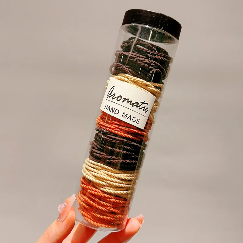 100 dark brown hair ties (one can)