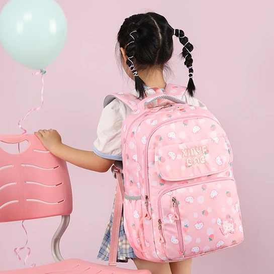 Cute pink school backpack with patches. Kids bag for school