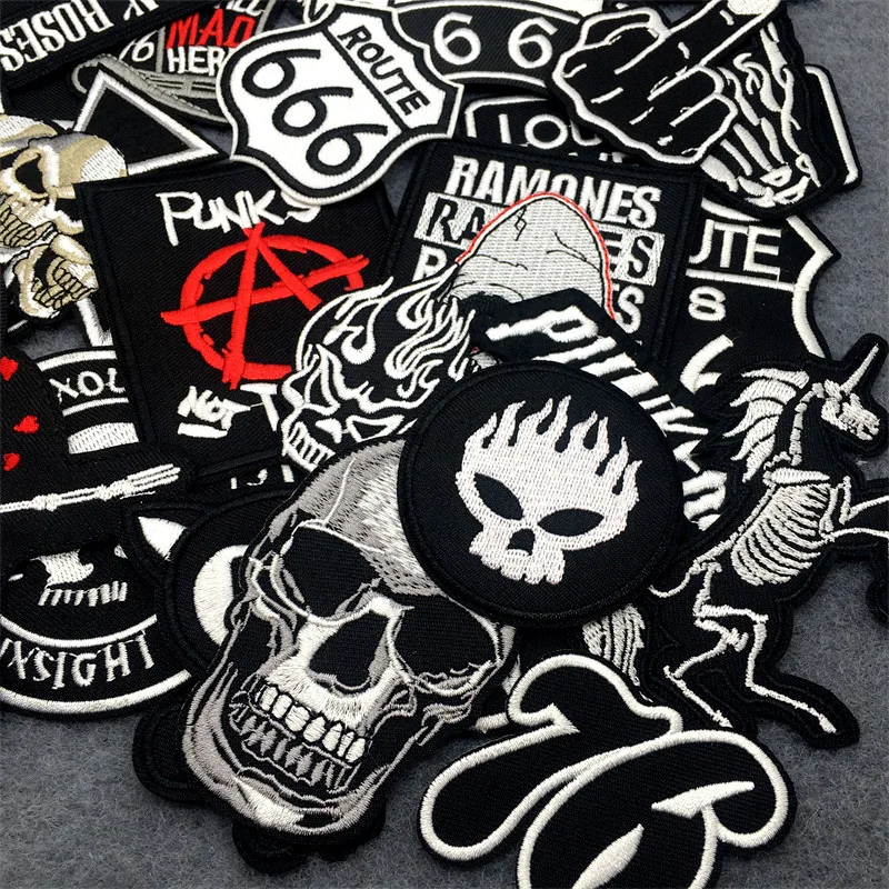 Collection of various patches with graphic designs and text on a gray background
