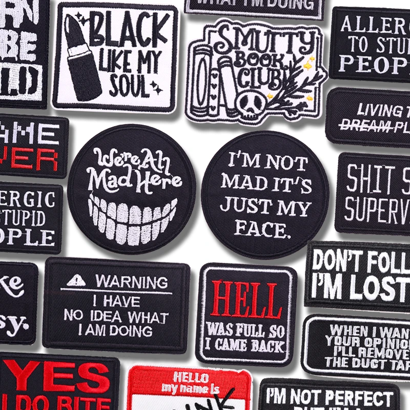 Gothic embroidered slogan patches with sarcastic quotes in black and white, including “Black Like My Soul” and “We're All Mad Here”