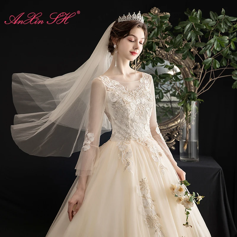 

AnXin SH princess flower champagne lace wedding dress vintage beading crystal o neck long flare sleeve white wedding dress