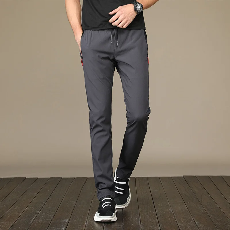 2024 pantaloni sportivi ad asciugatura rapida pantaloni da corsa da uomo con tasche con cerniera pantaloni sportivi da allenamento pantaloni sportivi Casual Fitness