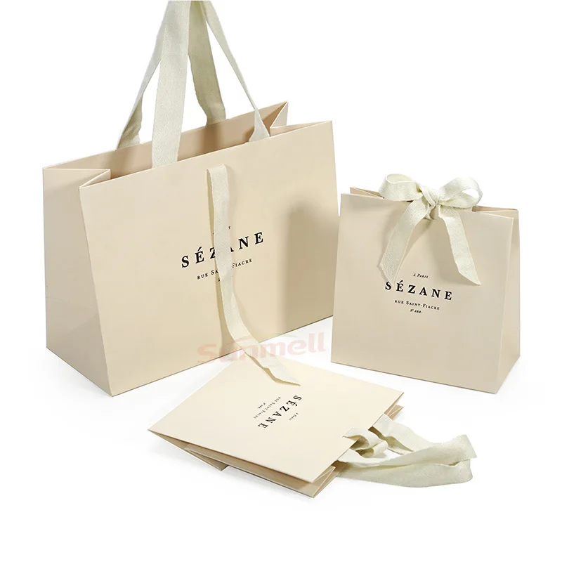 

Custom Recycled Ivory Clothes Packaging Gift Bag With Ribbon Handle Luxury Cream Beige Shopping Paper Bags With Your Own Logo