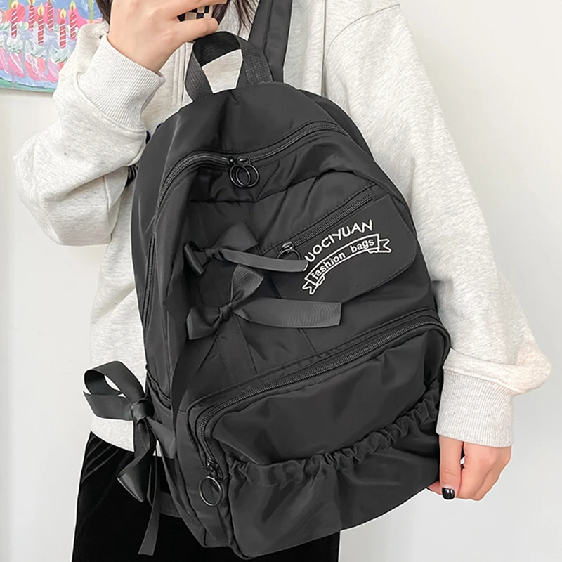 Stylish kawaii backpack with bowknot detail, designed for women and girls, featuring soft pastel tones and spacious compartments for school essentials.