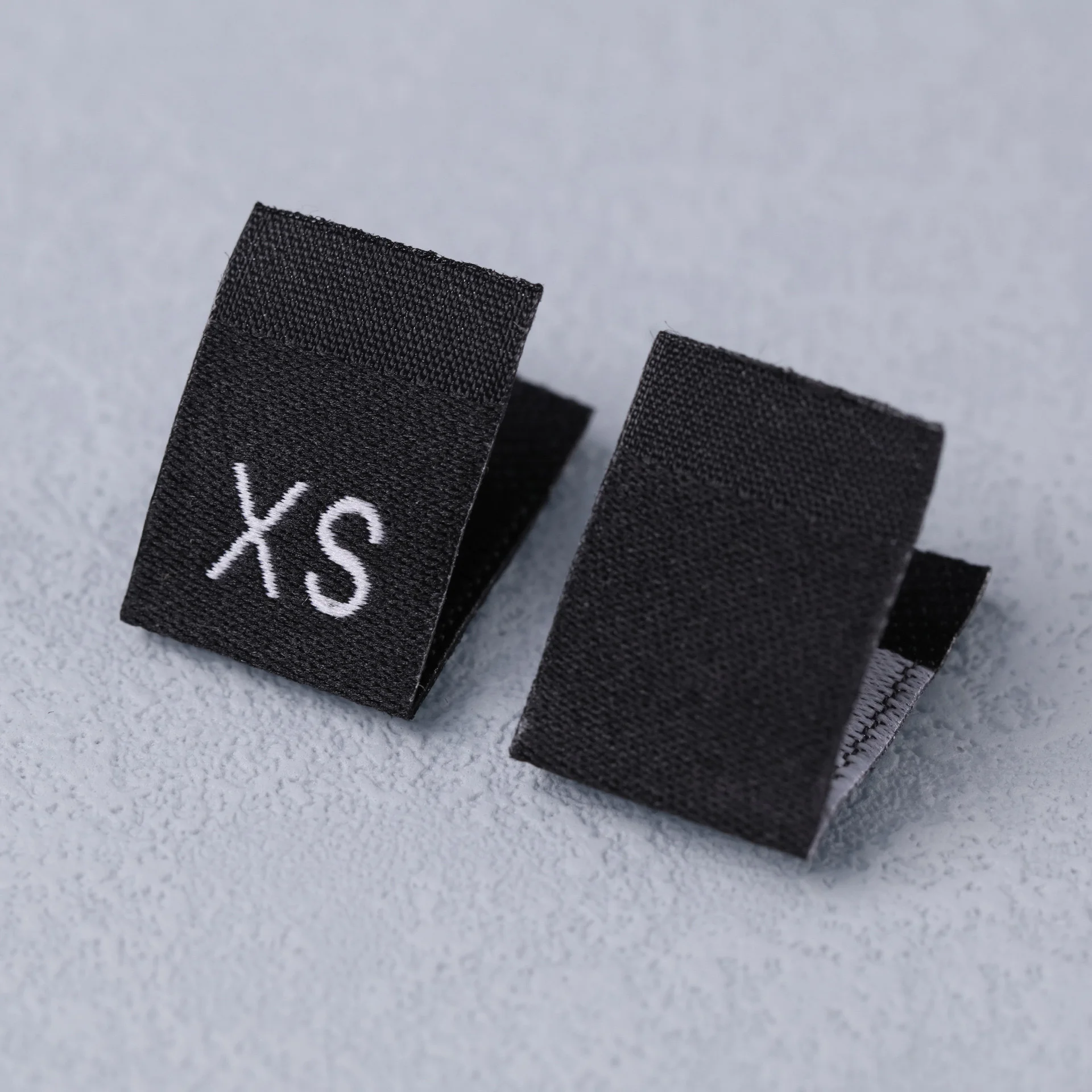 Description Picture 3 of item100Pcs Clothing Size Label Black Text White Garment Clothes T Shirt Dress Cloth Fabric Label Tag XS S M L XL 2XL 3XL 4XL 5XL 6XL
