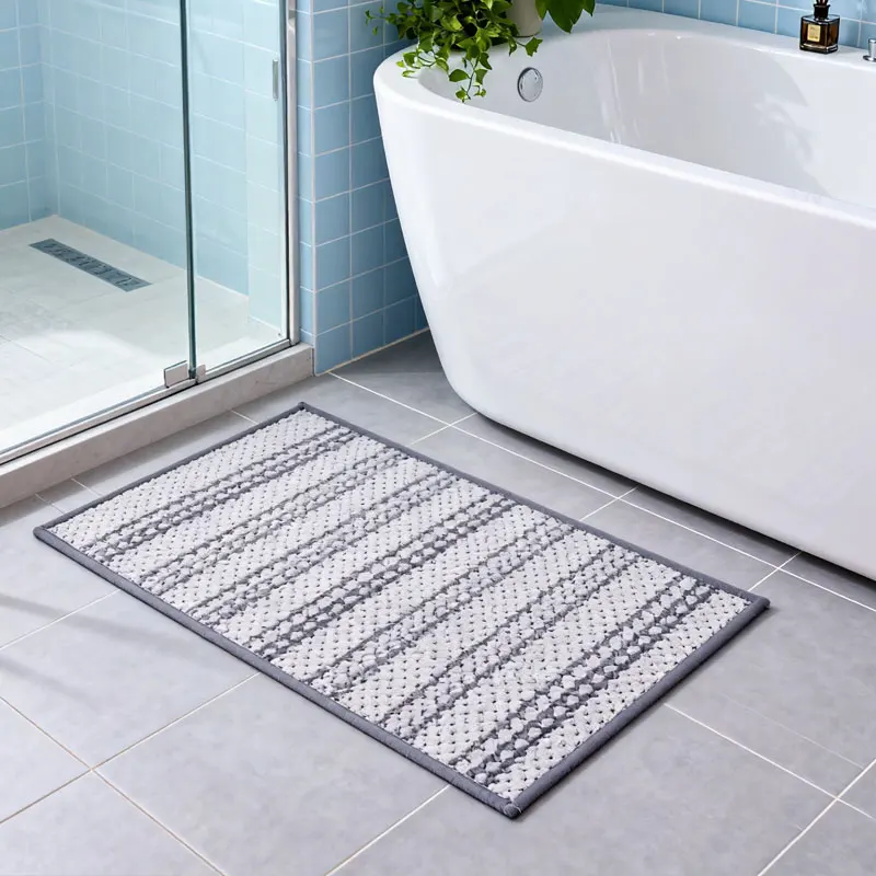 Plush gray bath mat with non-slip backing, quick-dry microfiber, for bathroom use.
