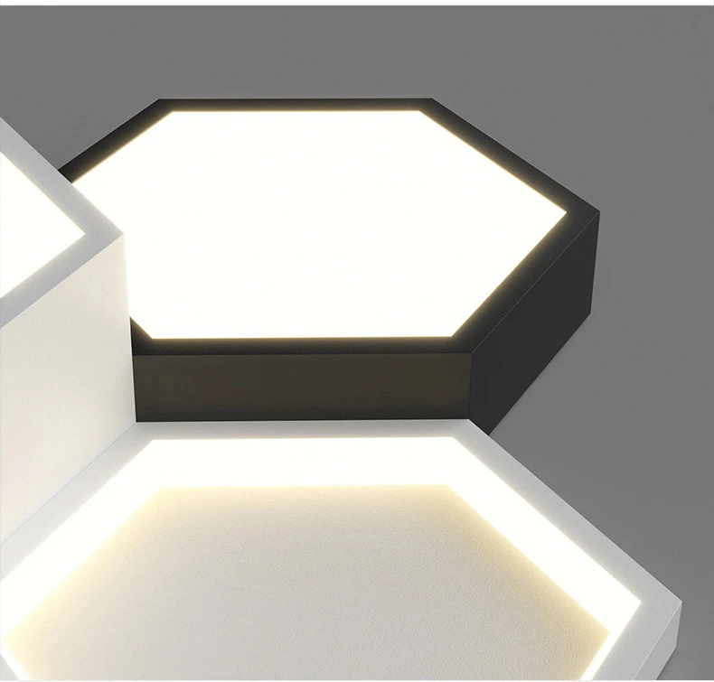 Hexagonal ceiling lights with illuminated borders on a dark surface, displaying minimalist design.