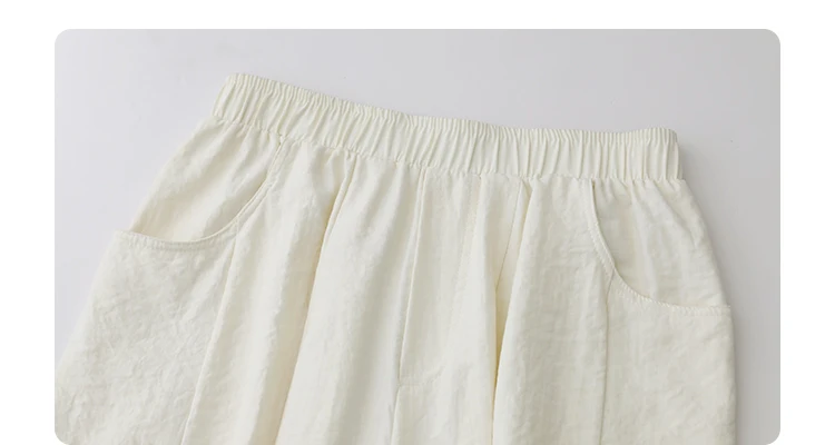 High-waisted pleated trousers details