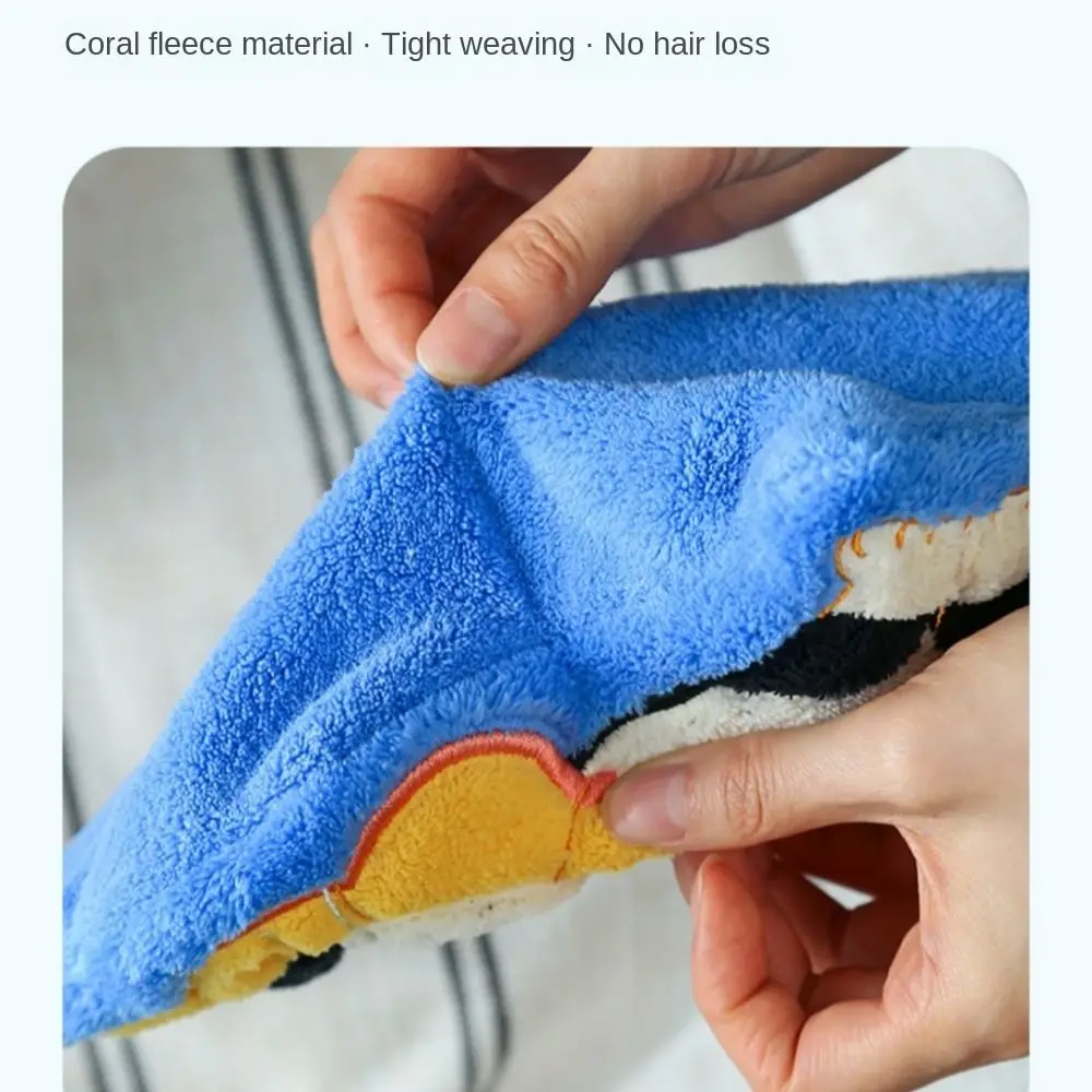 Hands stretching KittyNook Cat Co.'s soft, blue Premium Coral Fleece Kitchen Towel with strong water absorption.