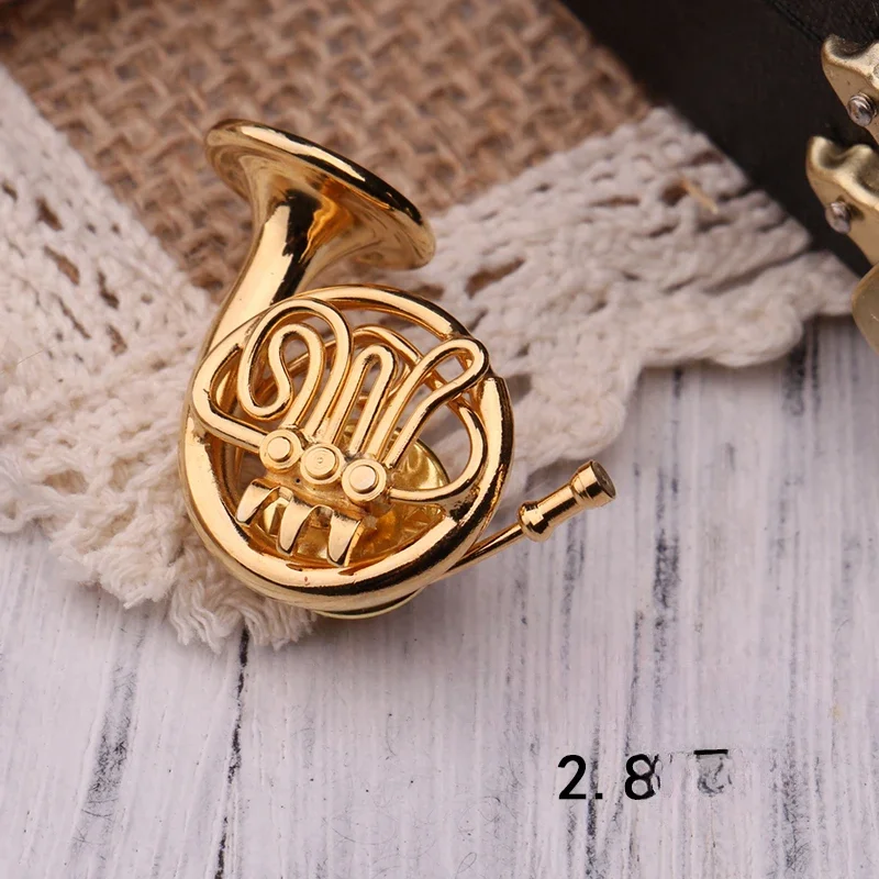 

Mini round gold-plated brooch and small flute model