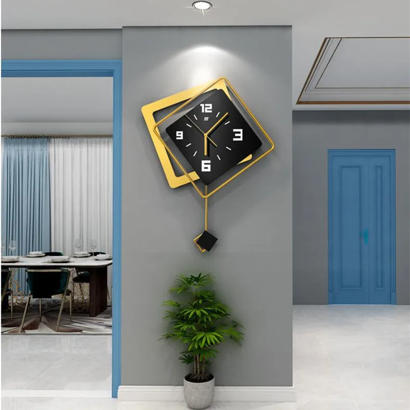 A modern and minimalist rhombus-shaped wall clock in a living room, featuring sleek black and gold tones.