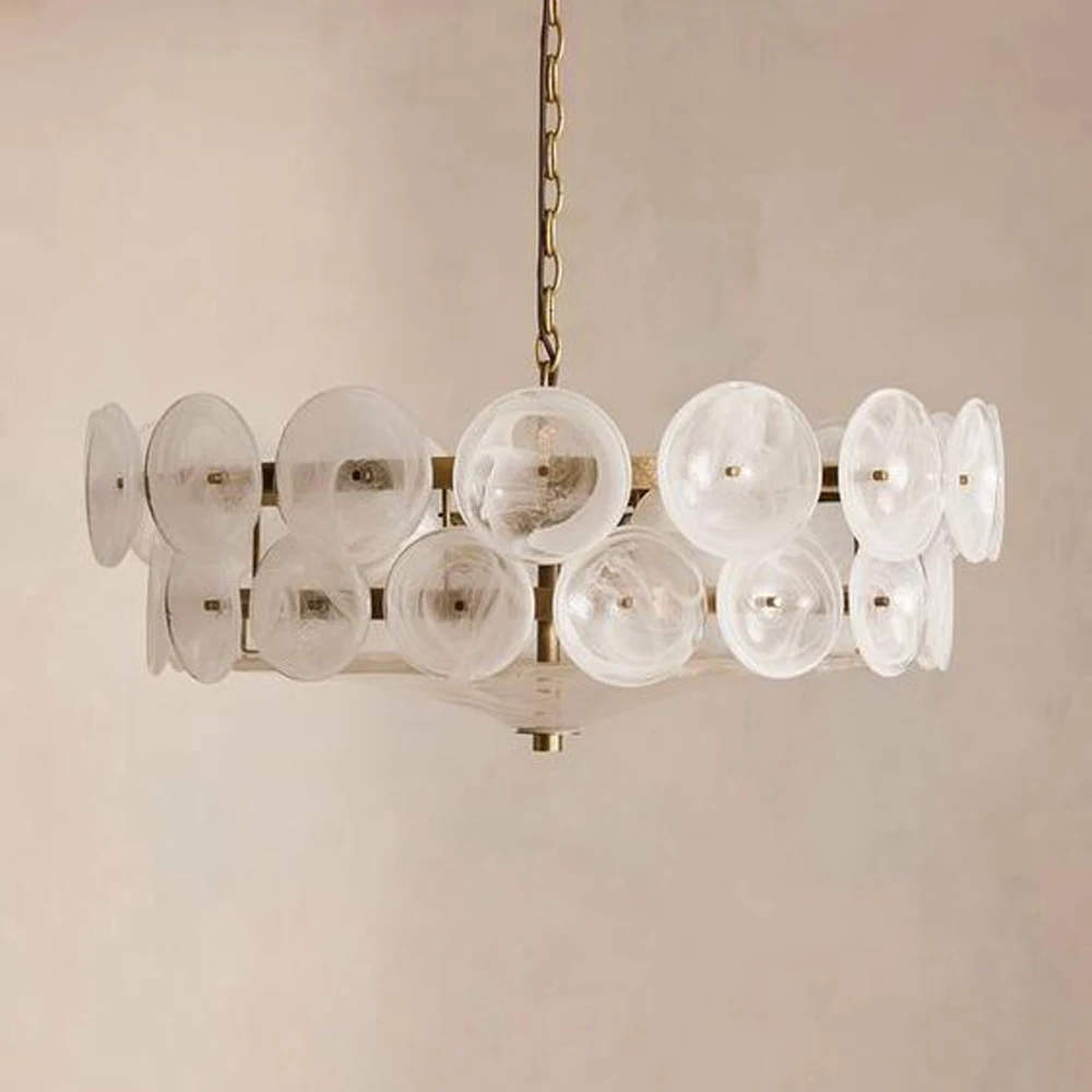 The Italian Retro Pendant Light features round Murano glass, a brass fixture, and clear decorative discs hanging from a chain against a neutral wall, highlighting exquisite Italian artisan lighting.