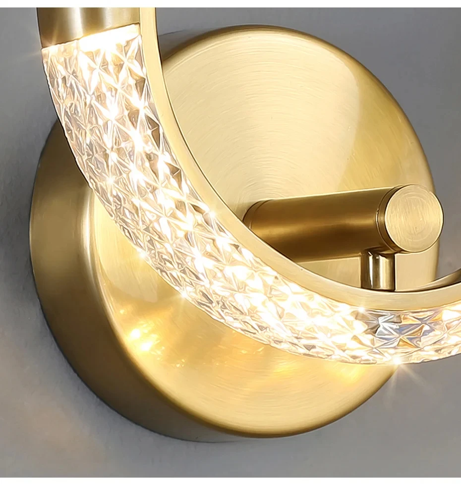 Close-up of the Luxury Wall Sconce, a modern and stylish, circular gold LED fixture featuring illuminated, textured glass.