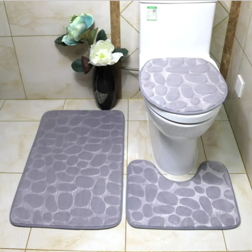 Cobblestone-patterned non-slip bath mat with textured surface, absorbent and washable.