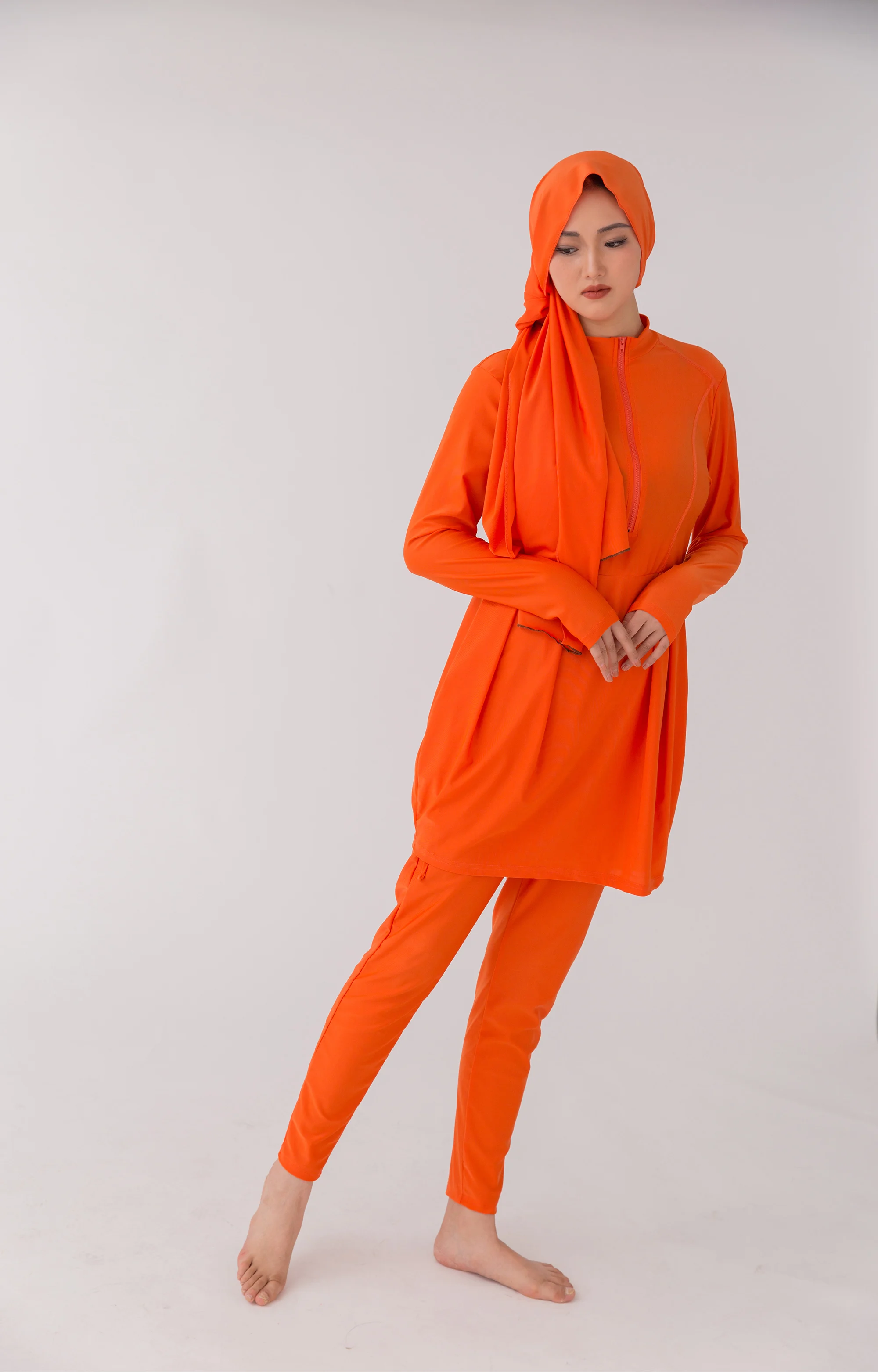 Close-up of zipper and stitching detail on the modest swim tunic