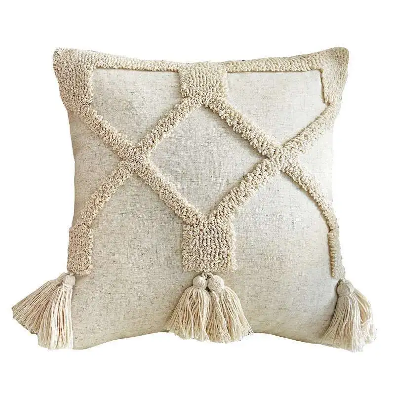 Design A beige tufted square pillow cover with tassels