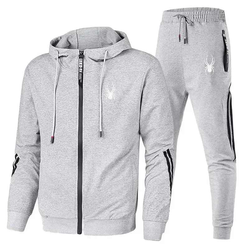 Man wearing casual zipper jacket and jogger pants set in an outdoor fitness or streetwear setting white