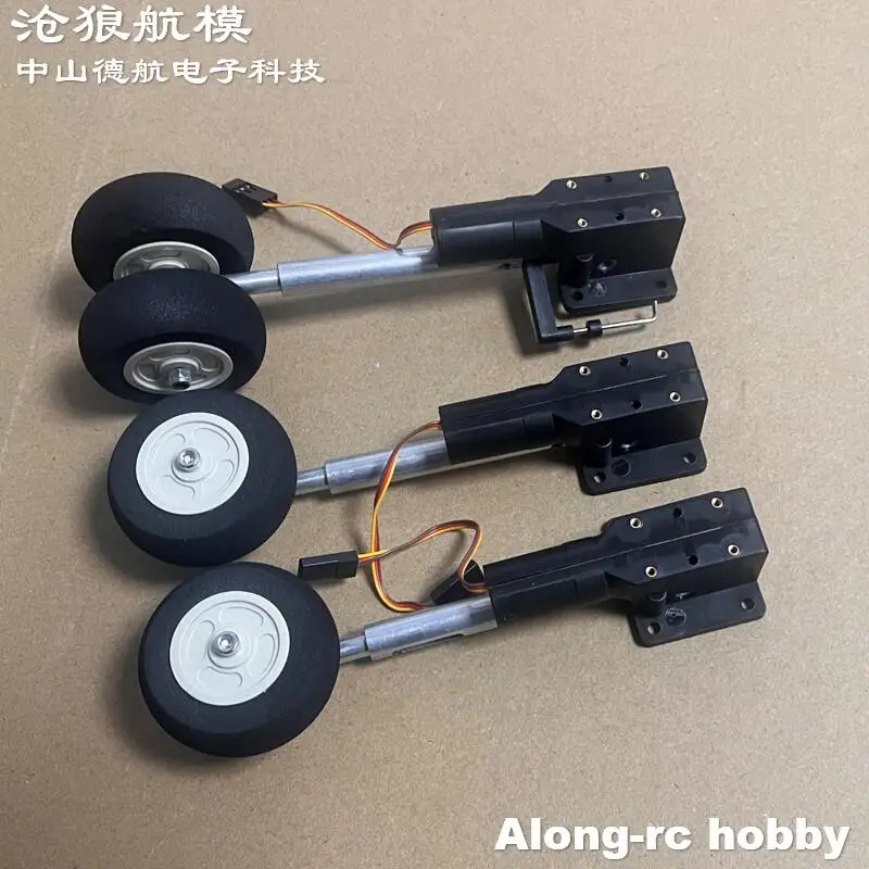 Train d'atterrissage pour avion RC en alliage, présentant les deux roues principales et la roue de nez, prêt à être installé.