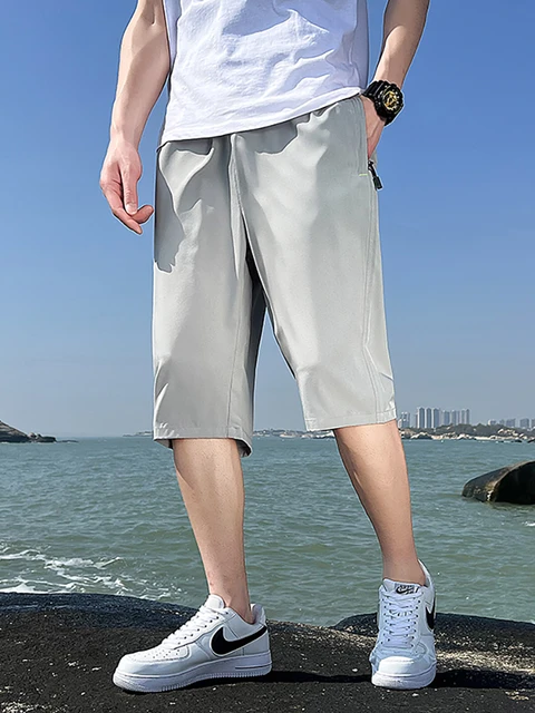 ASOS DESIGN wide awkward length nylon pants with toggle detail in black |  ASOS