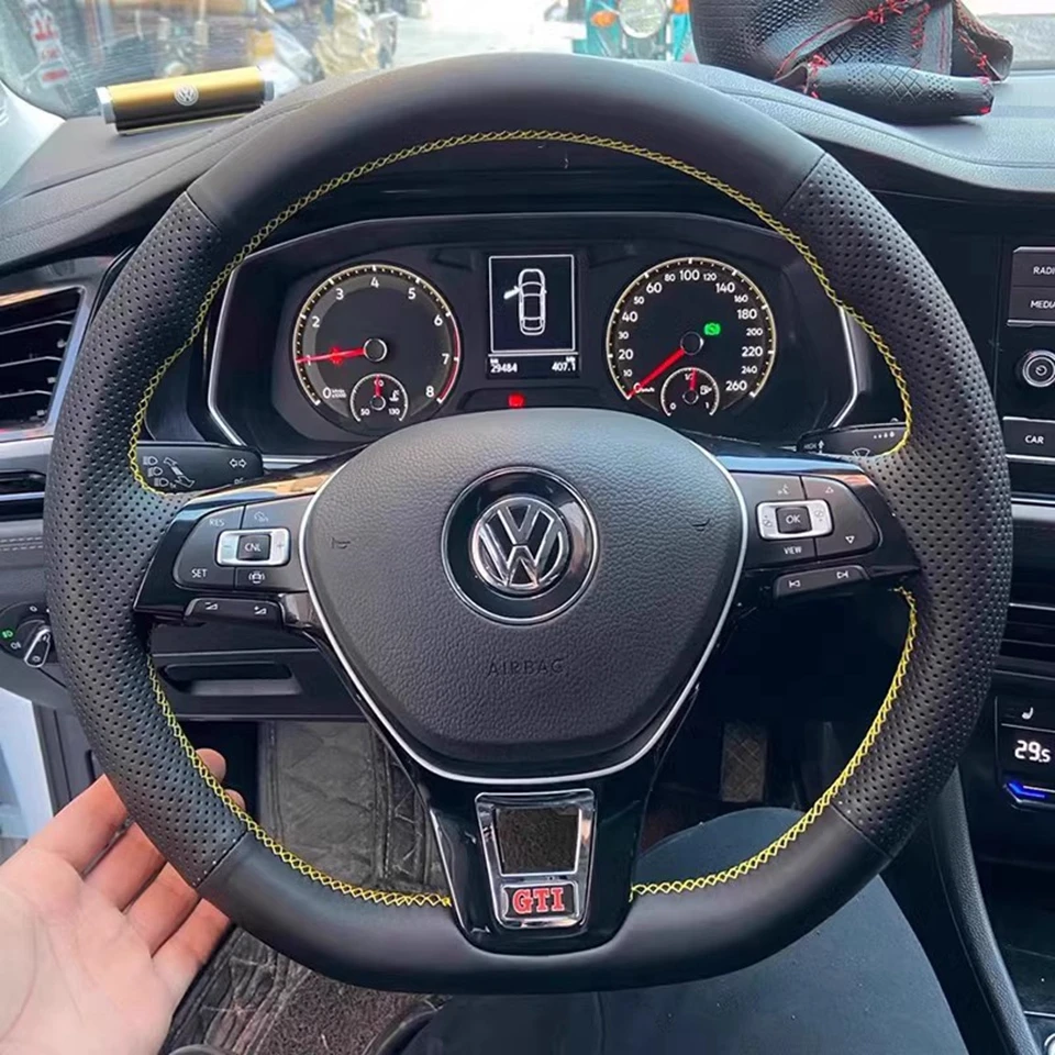 Installed black leather VW steering wheel cover in a Volkswagen interior