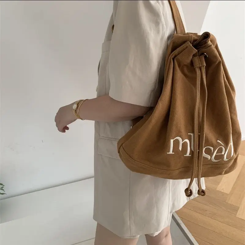 

Korean Ins 2023 New Drawstring Backpack Embroidered Letter Large Capacity Bucket Bag Canvas Solid Simplicity Travel Bag Tote Bag
