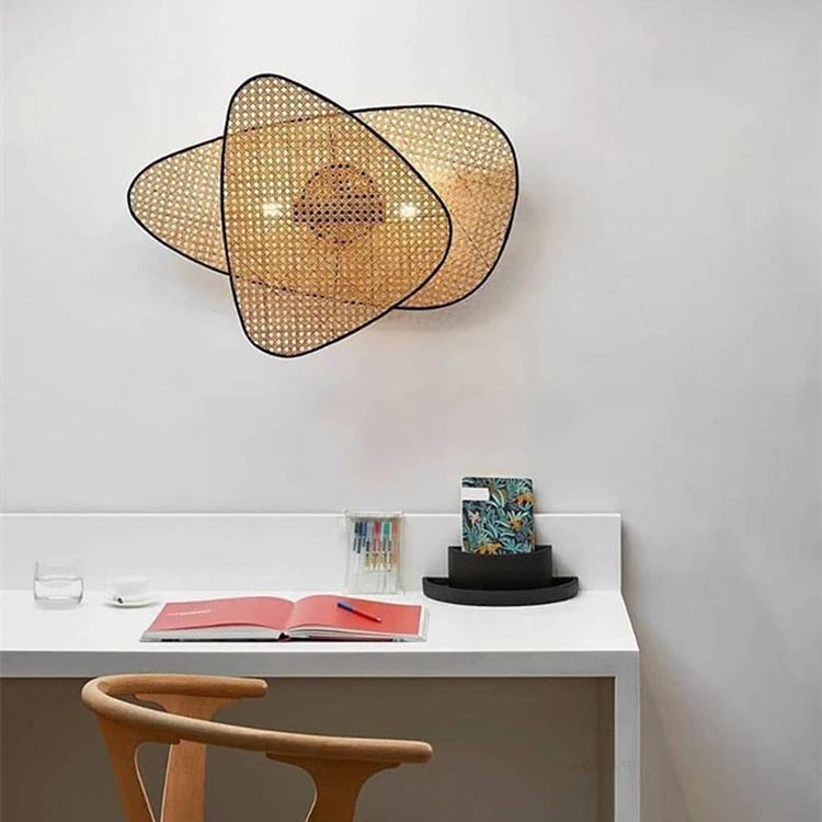 A desk with an organic meets modern lamp and a chair in front of it.