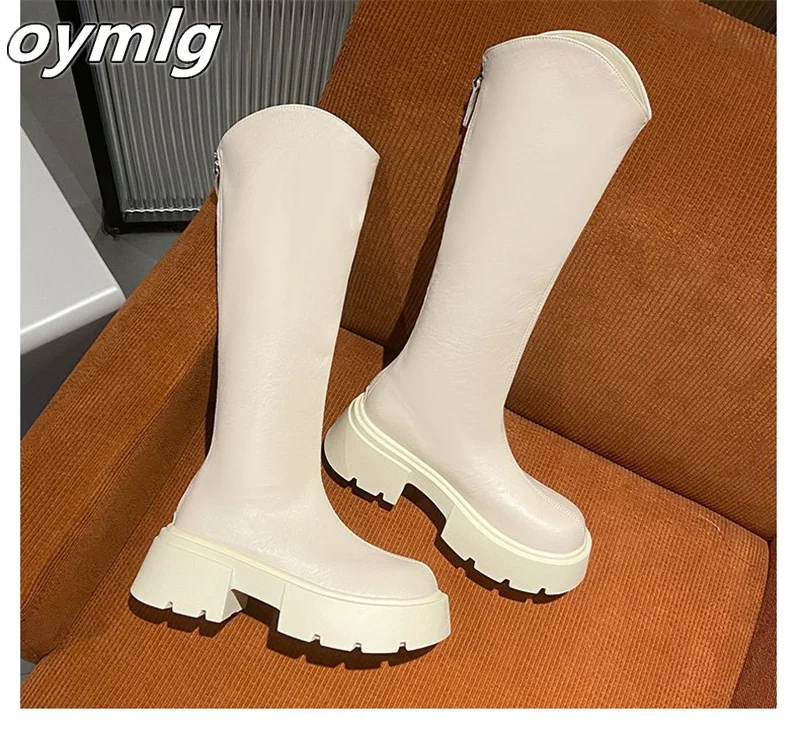 Thick heeled boots that are no less than knee high and appear slim with V-shaped boots