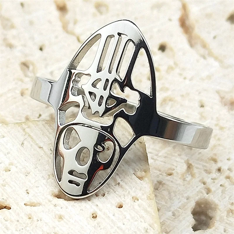 Silver color ring with intricate design on a textured beige surface