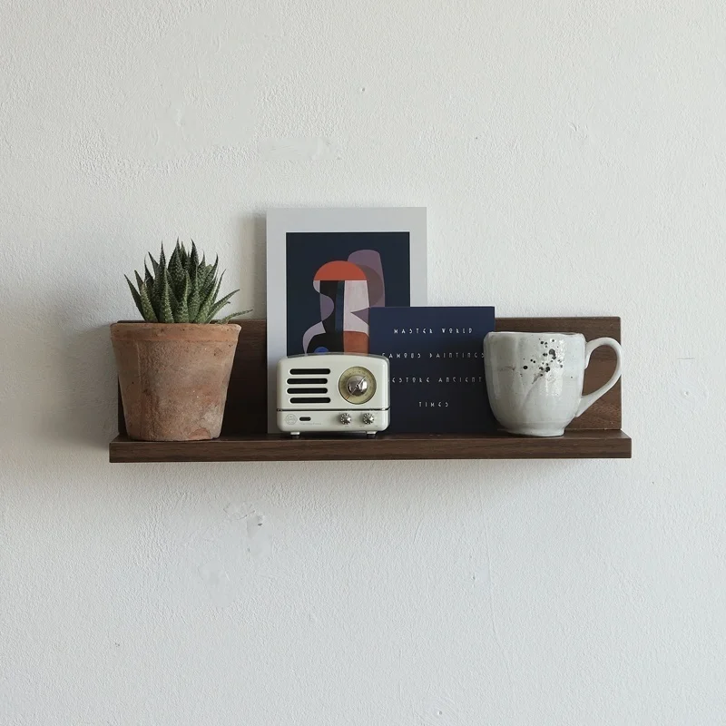 There is a small wooden frame on the wall, a flat partition in the bedroom and kitchen, and a