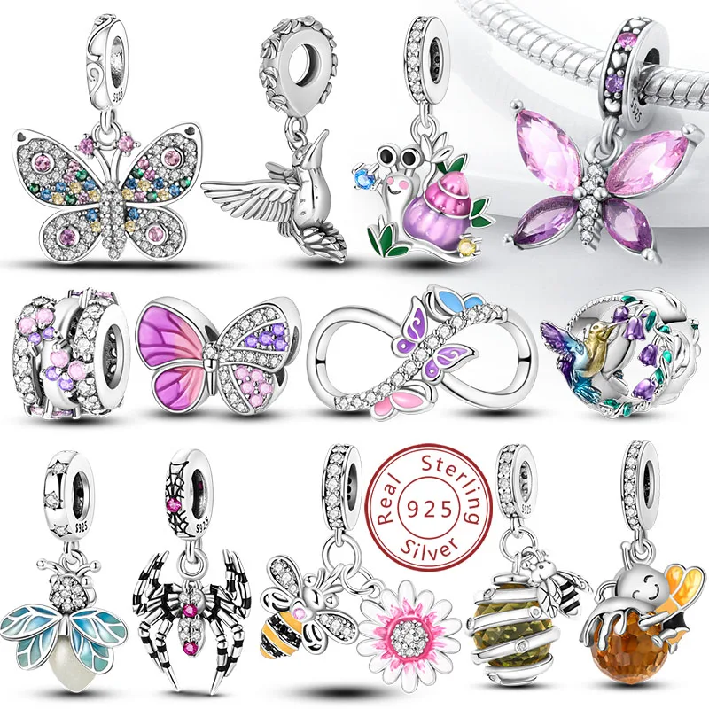 Sterling silver insect and bird charms displayed on a bracelet