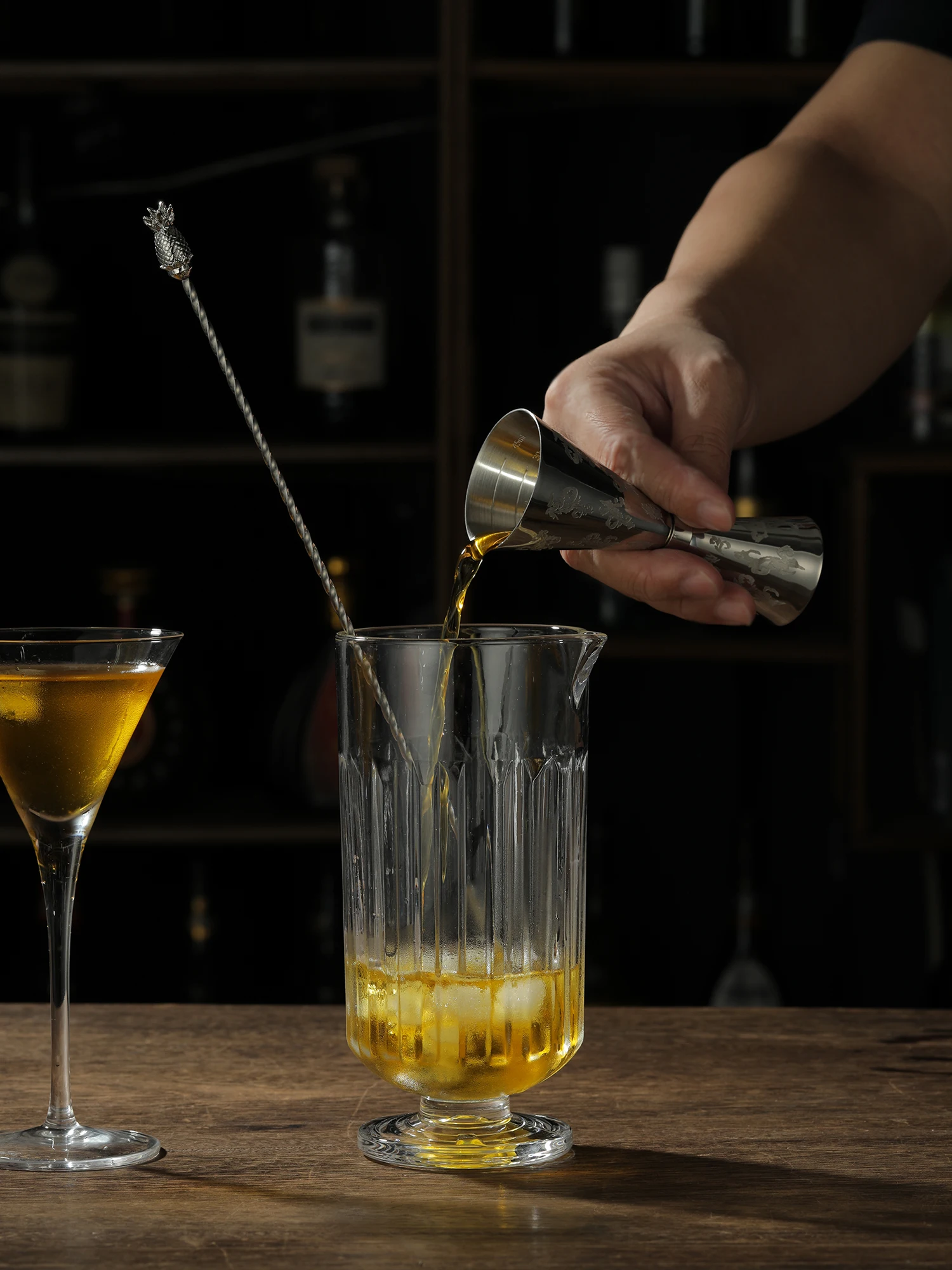 Assorted stainless steel cocktail jiggers for precise drink measurement in different sizes and finishes