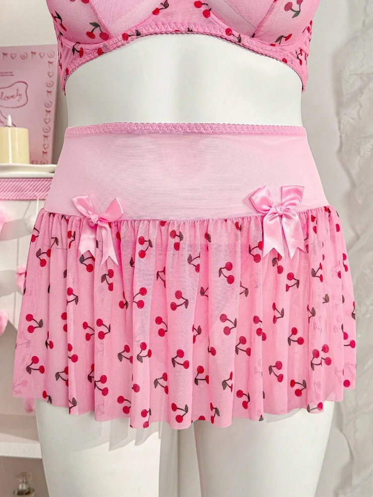 Bra detail with cherry pattern, slim straps, and sweet bow accent