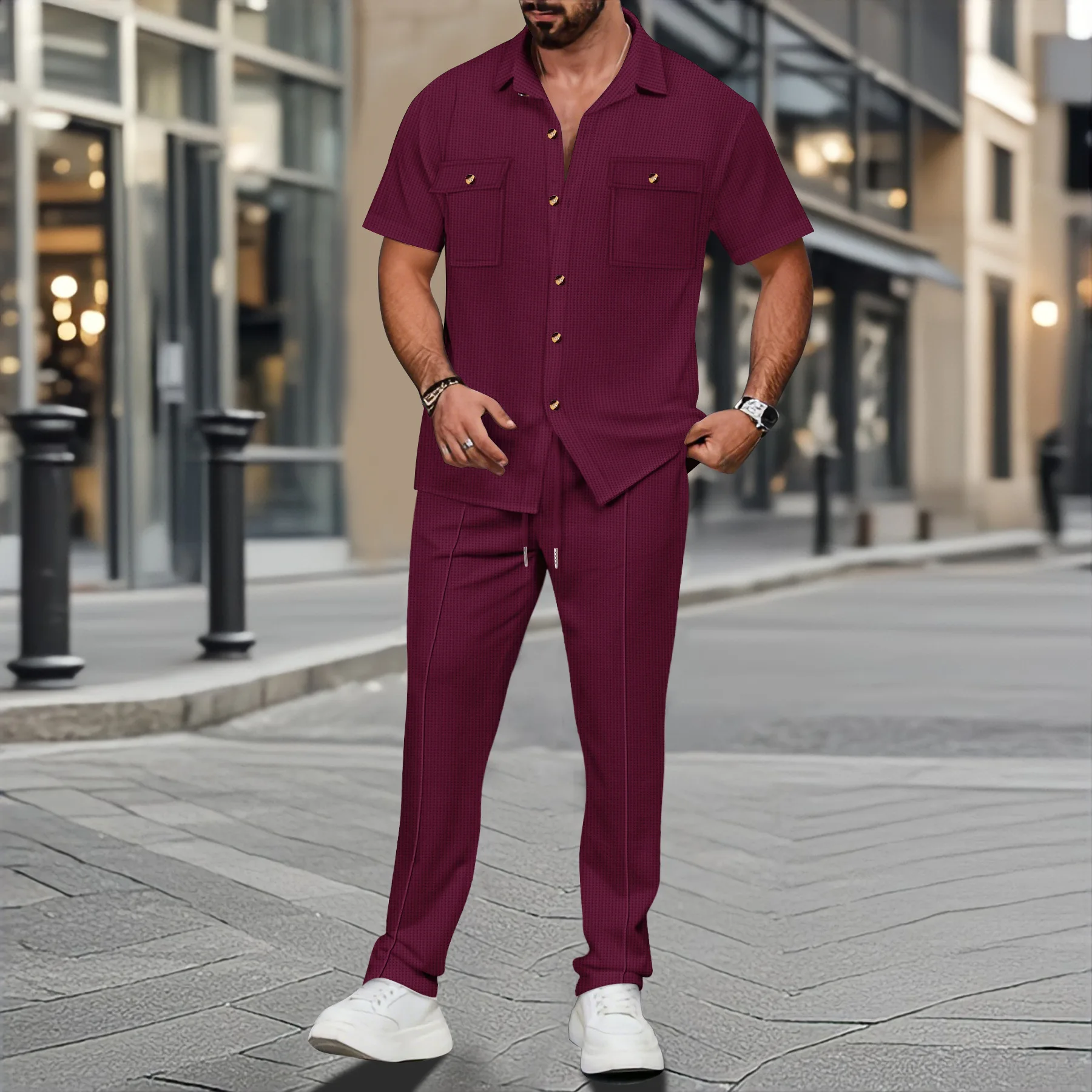 Men’s solid color waffle check short sleeve shirt and trousers two-piece set displayed on model in outdoor travel setting red