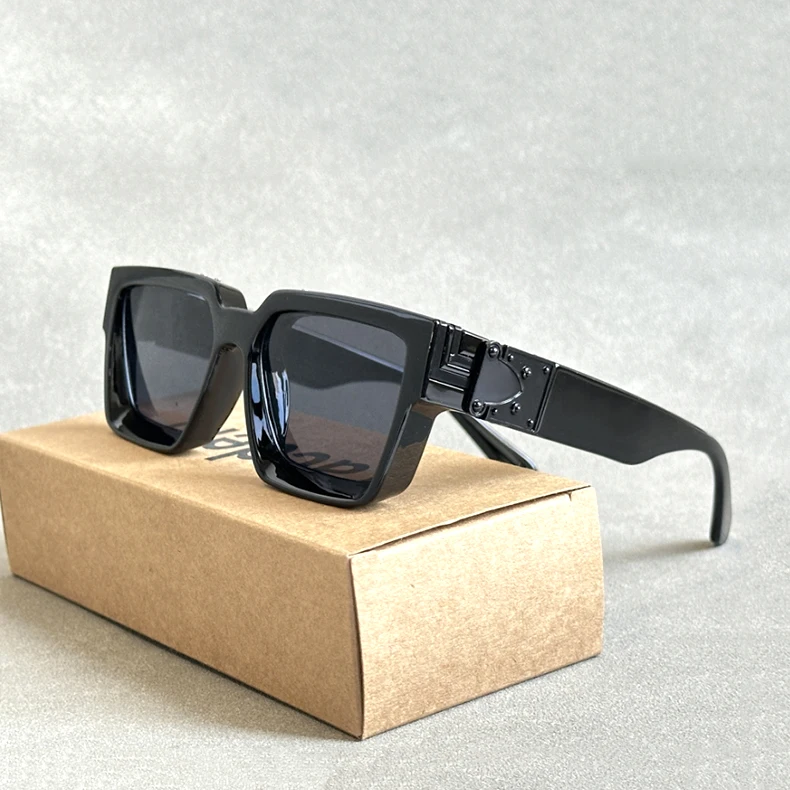 A pair of luxury designer square sunglasses from the collection "Sunglasses For Men Vintage Sunglasses Women" with UV400 protection is placed on a closed, brown cardboard box. The background features a light gray surface.