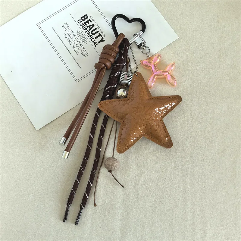 מחזיק מפתחות דקורטיבי חמוד עם תליון כוכב ים מעור PU חדשני עם חבל מתולתל לתיקים