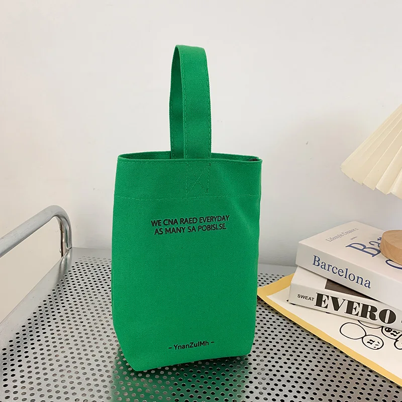 

2023 New Minimalist Style Mini Portable Canvas Bag Lunch Bag Candy Color Kettle Wrist Strap Plain Canvas Bag