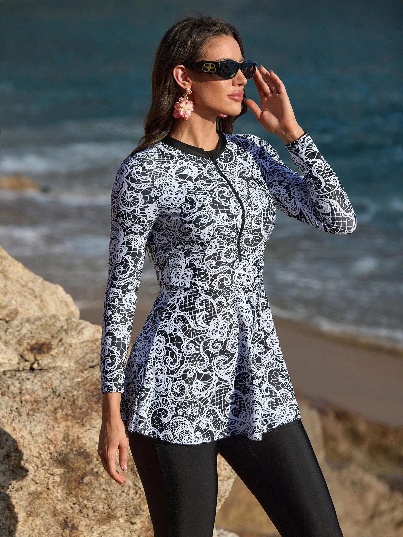 Flowing hemline of burkini top with contrast black leggings.