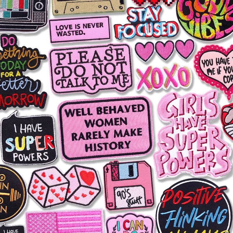 Pink embroidered patches with empowering quotes like "Girls Have Superpowers", "Please Do Not Talk to Me", and "XOXO"