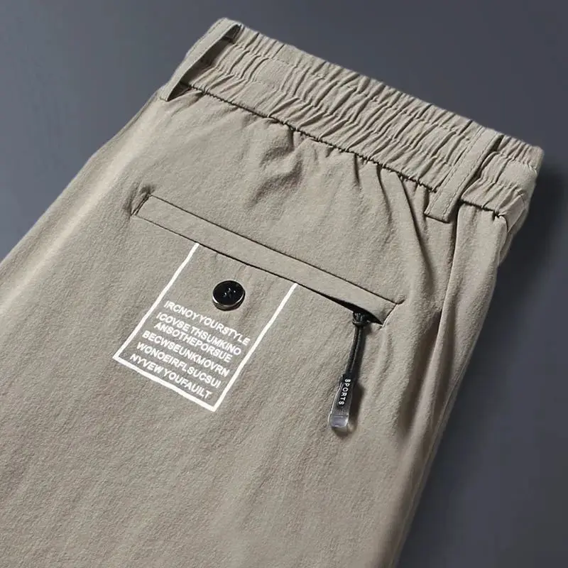 2024 New Summer Men's Ice Shreds Thin Style Trousers Solid Color Elastic Button Zipper Fashionable Loose Casual Harlan Pants