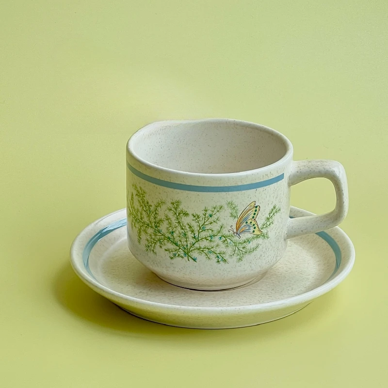 Medieval coffee cups and saucers, green plants and butterflies, medieval cups