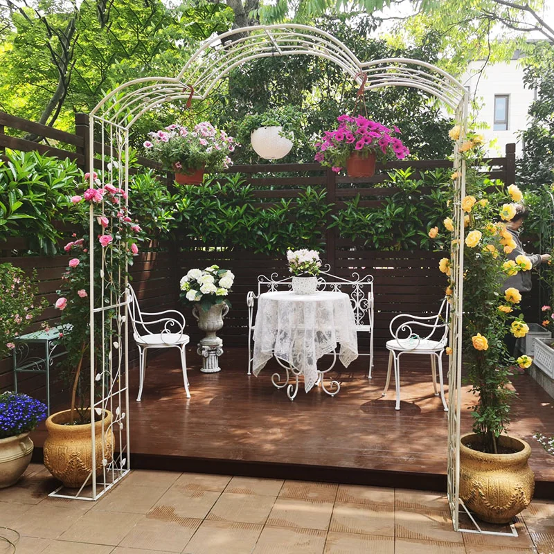 Metal garden trellis arch serves as garden arch and supportive trellis for climbing plants