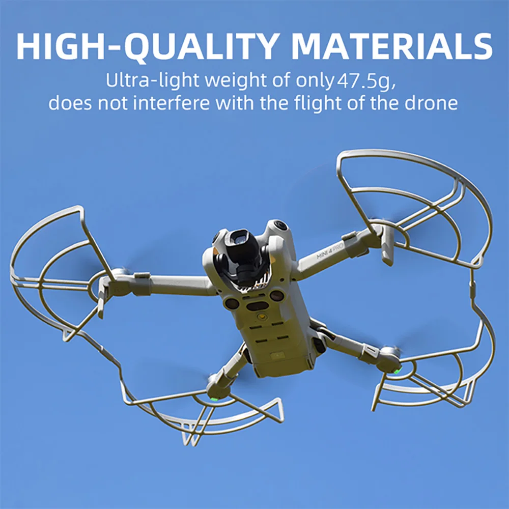Deux protège-hélices pour drone gris clair posés sur une surface, accessoire de sécurité essentiel pour pilotes.
